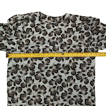 Floral patterned shirt with a measuring tape on a white background