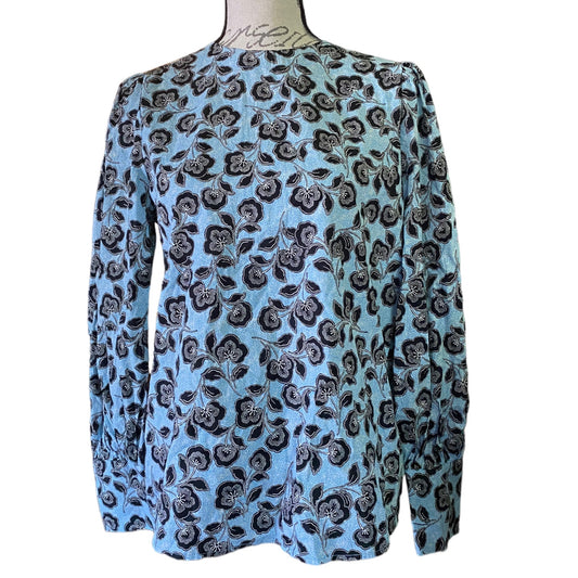 Front of Blue floral patterned blouse on a mannequin against a white background