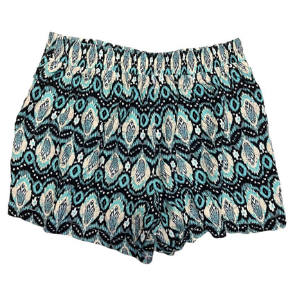 A pair of women's shorts featuring an all-over geometric ikat pattern on a white back grounf