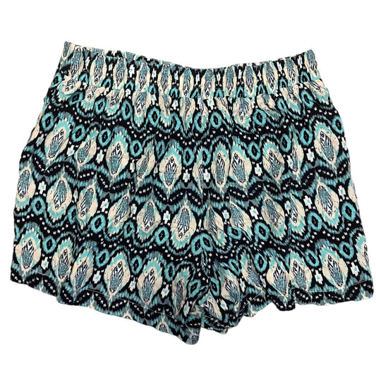 A pair of women's shorts featuring an all-over geometric ikat pattern on a white back grounf