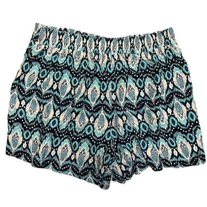 A pair of women's shorts featuring an all-over geometric ikat pattern in blue, black, and cream, displayed flat against a solid white background.