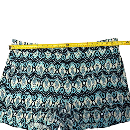Patterned shorts with  geometric ikat design, shown with a yellow tape measure across the waistband to indicate size.