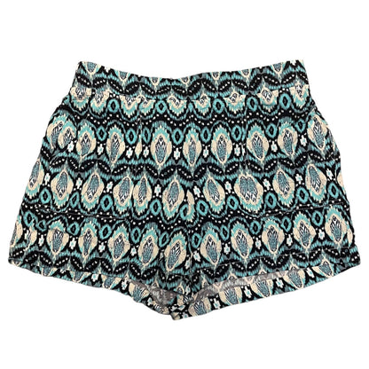A pair of women's shorts featuring an all-over geometric and paisley-style pattern in black, blue, and cream, displayed flat against a solid white background.