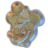 Metallic Mickey Mouse-shaped cake pan on a white background