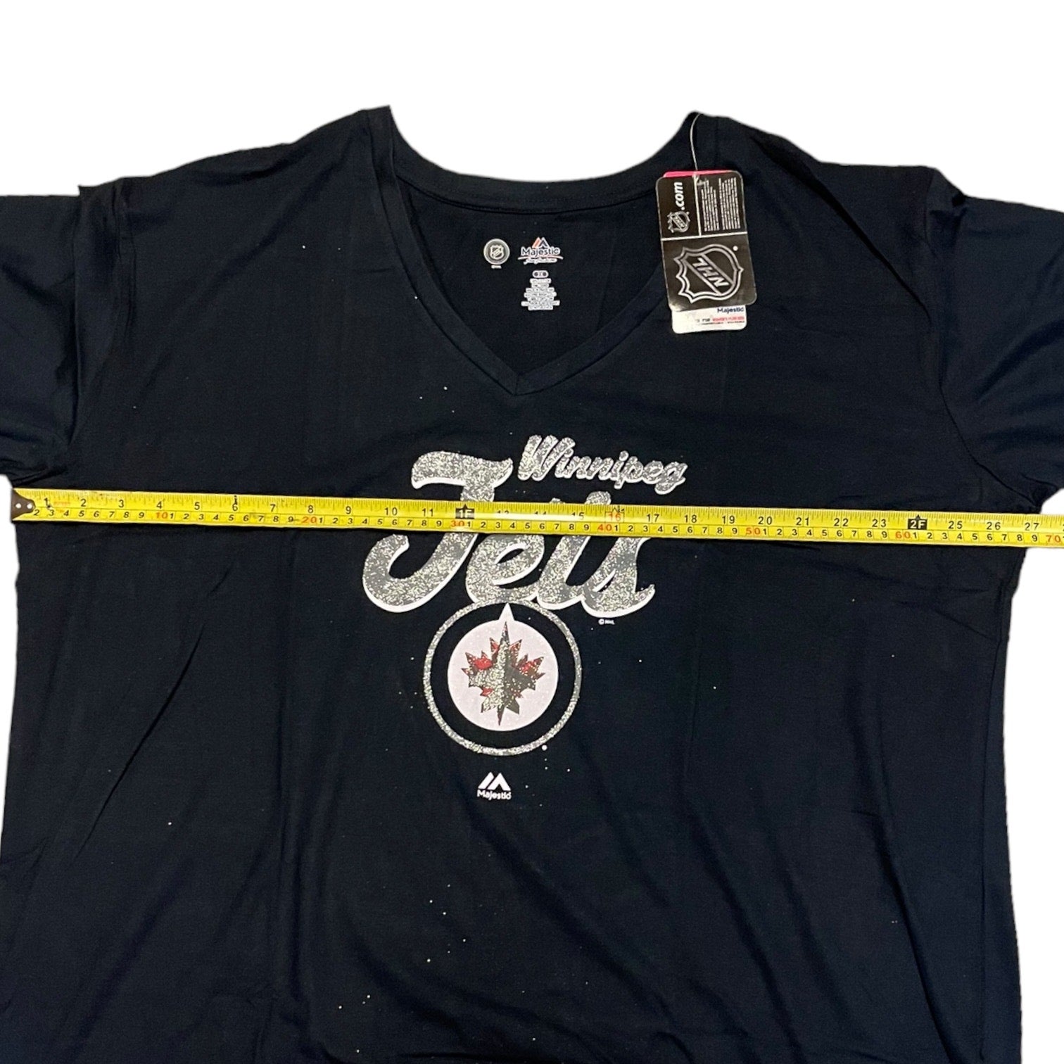 Blue t-shirt with 'Winning Jets' text and logo, measured with a tape measure.