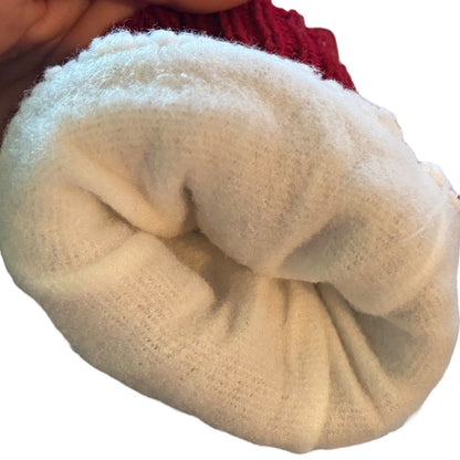 Interior of red gloves, plush white fabric with a red textured knit edge visible at the top, held against a plain white background.