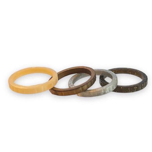 Set of four rings in different colors on a white background