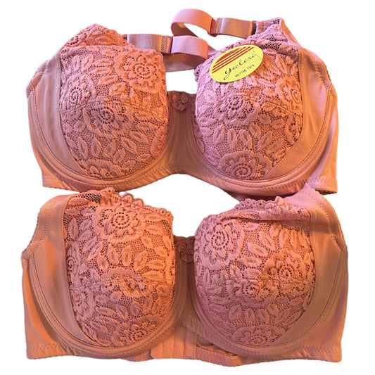 Pink lace bra set with a visible brand tag on a white background