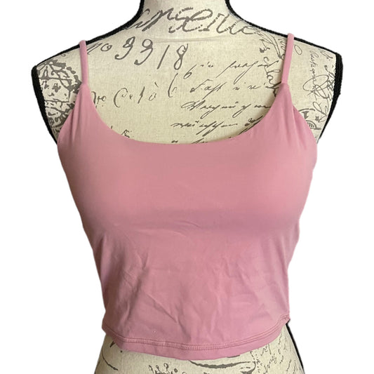 A pink spaghetti-strap sports bra displayed on a vintage-style paper-covered dress form mannequin against a white background.