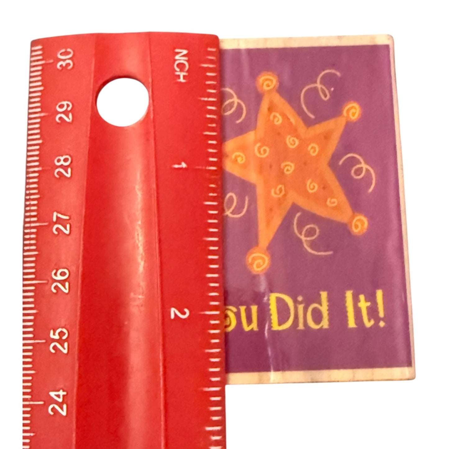Red ruler 2.5"H with a star design stamp block on a white background