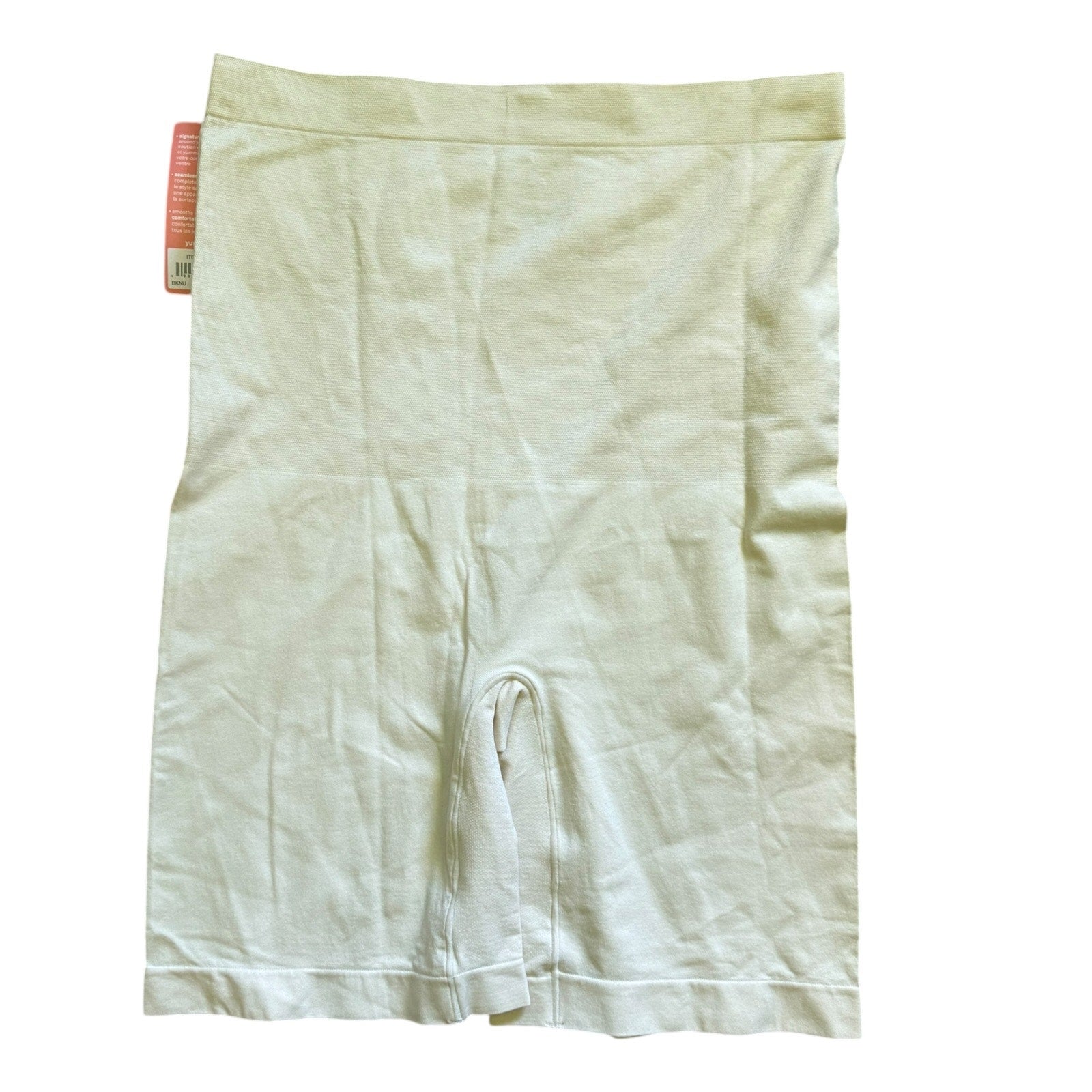 Beige shapewear shorts with a visible brand tag on a white background