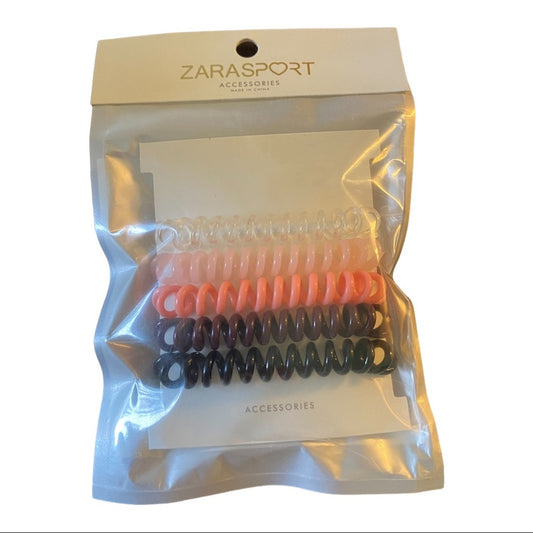 A package of five spiral hair ties in assorted colors, presented in a clear plastic bag with a beige header card labeled 'ZARASPORT ACCESSORIES'.