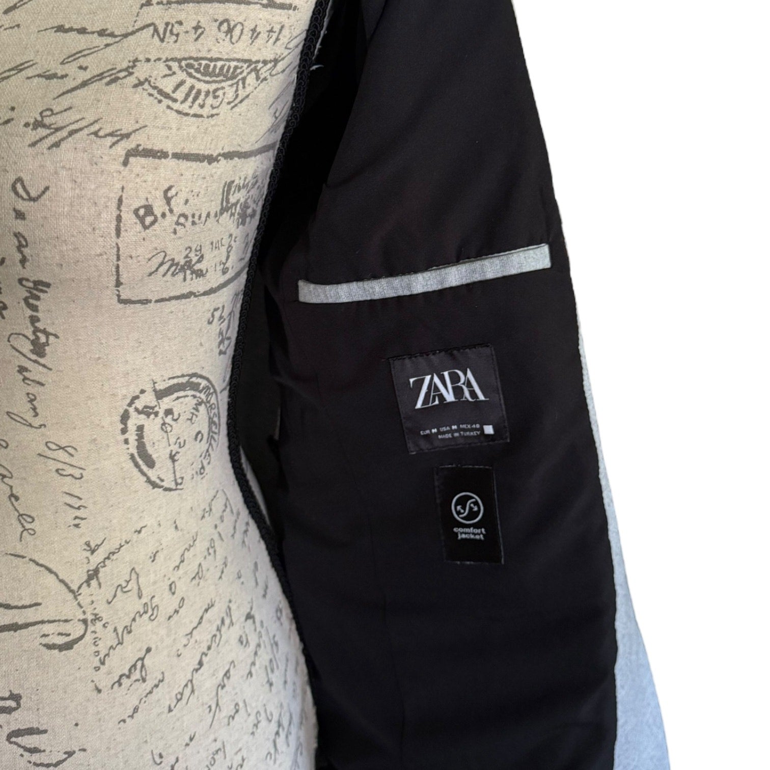 Interior of jacket with Zara label on a textured background