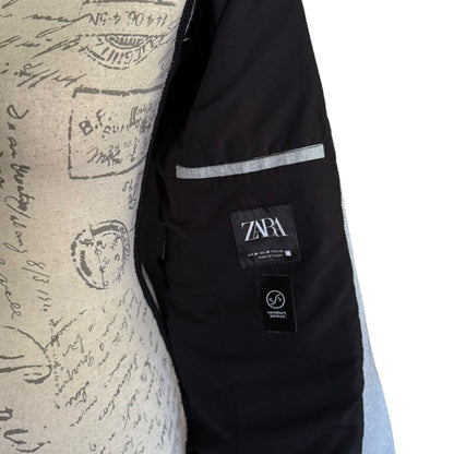 Interior of jacket with Zara label on a textured background
