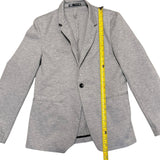 Gray blazer with a measuring tape on a white background