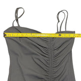Gray strapless top with a measuring tape indicating its width on a white background