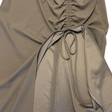 Close-up of a gray dress with a tie detail on a white background
