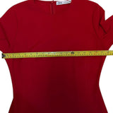 Red shirt with a measuring tape around the chest area on a white background