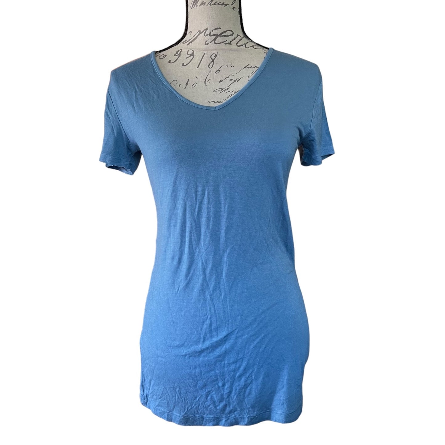 A blue short-sleeve V-neck t-shirt displayed on a dress form mannequin against a white background.