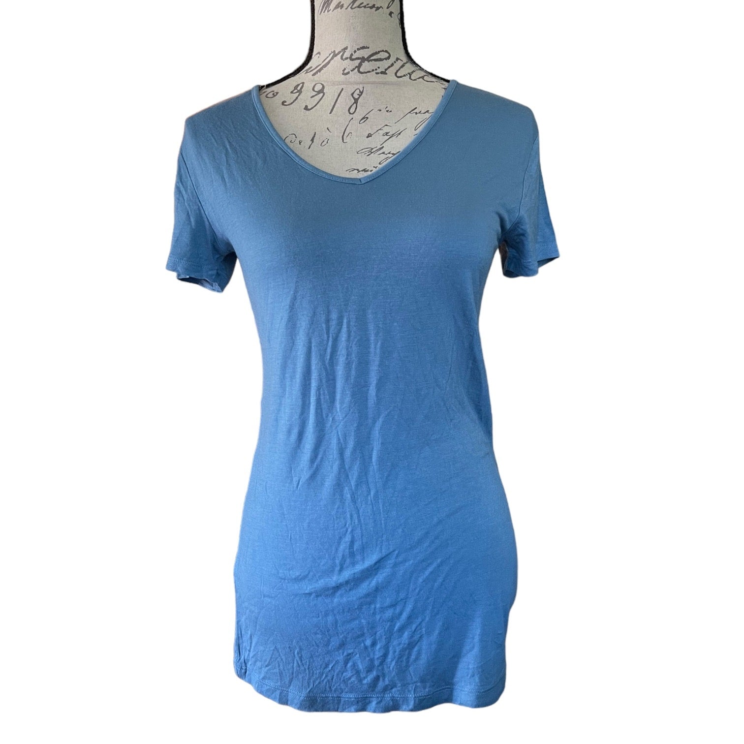 A blue short-sleeve V-neck t-shirt displayed on a dress form mannequin against a white background.