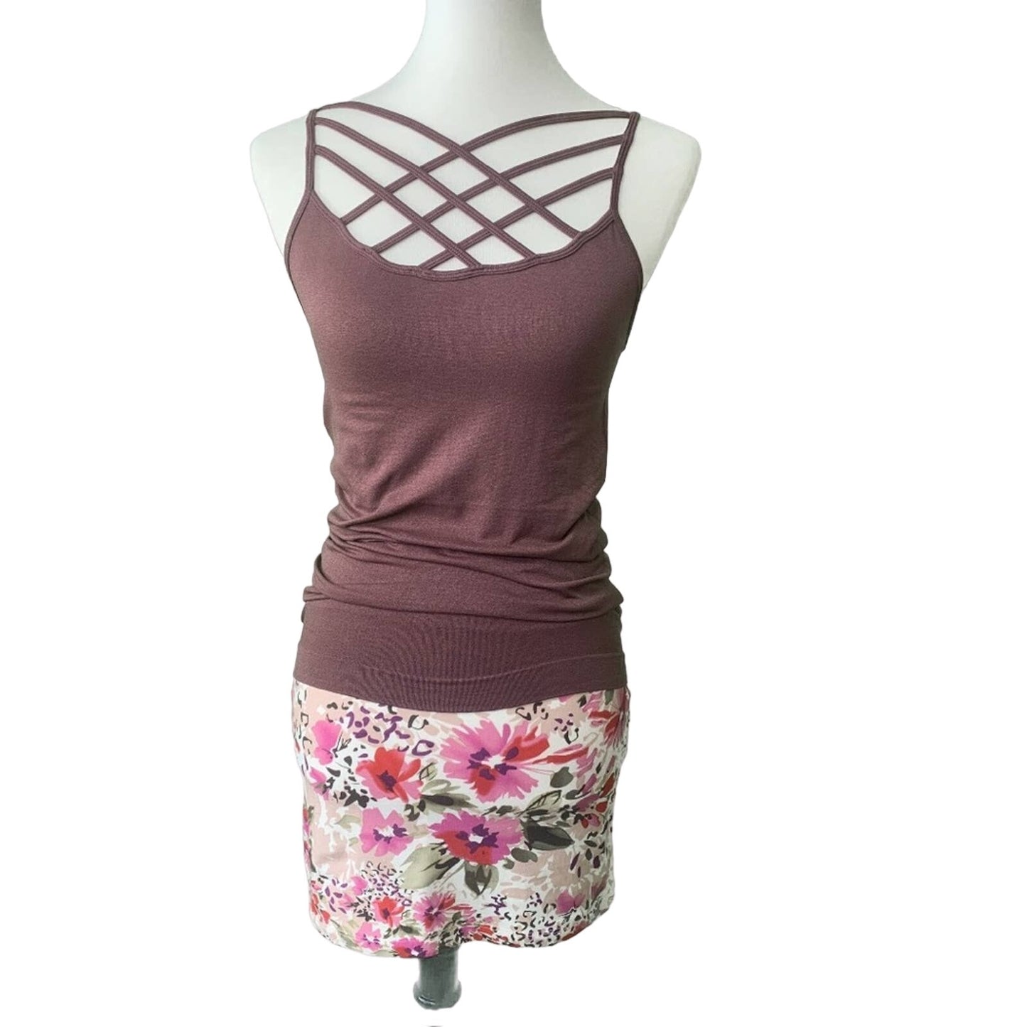 Mannequin wearing a purple tank top and floral skirt on a white background