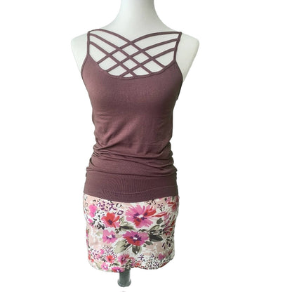 Mannequin wearing a purple tank top and floral skirt on a white background