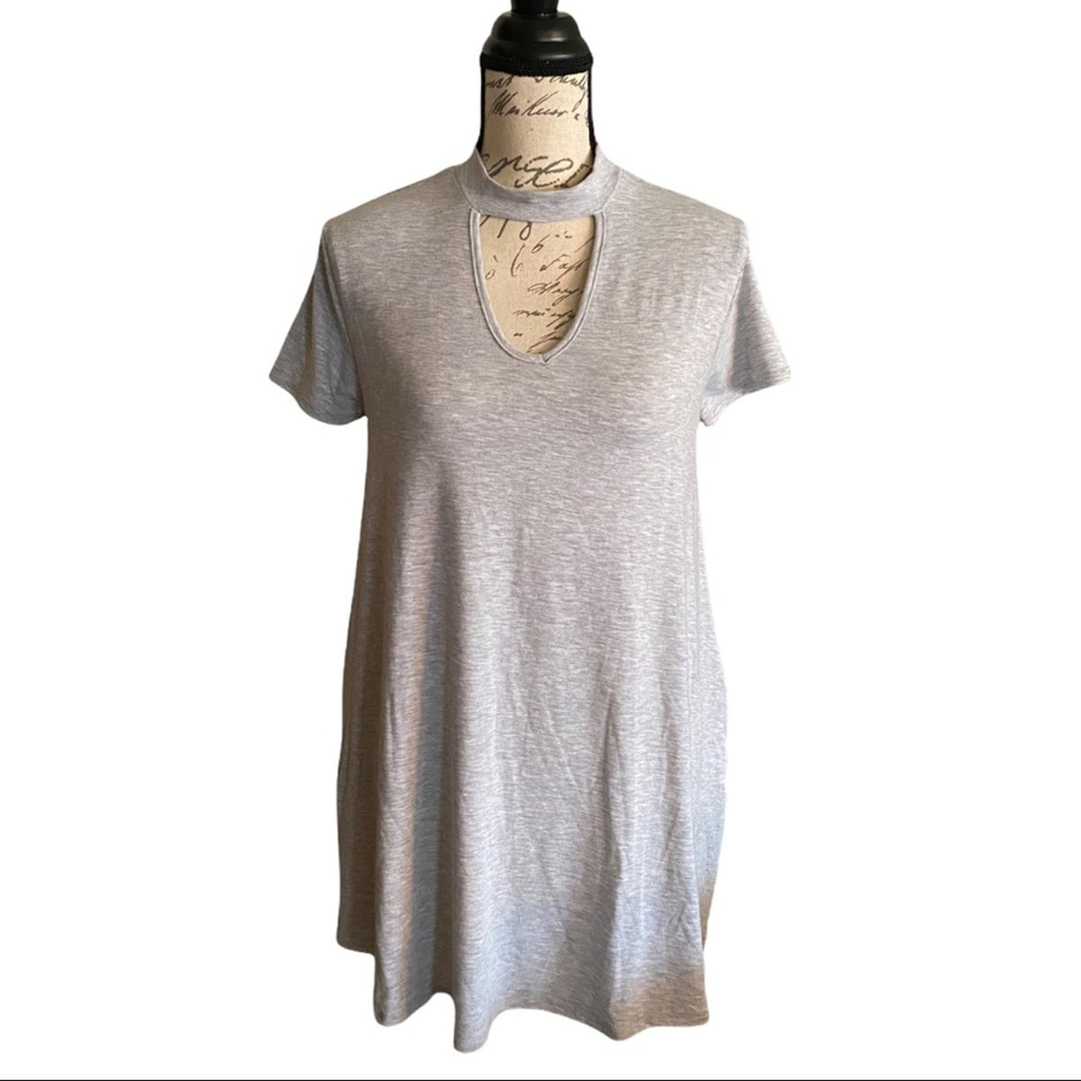 Gray tunic front on a mannequin against a white background