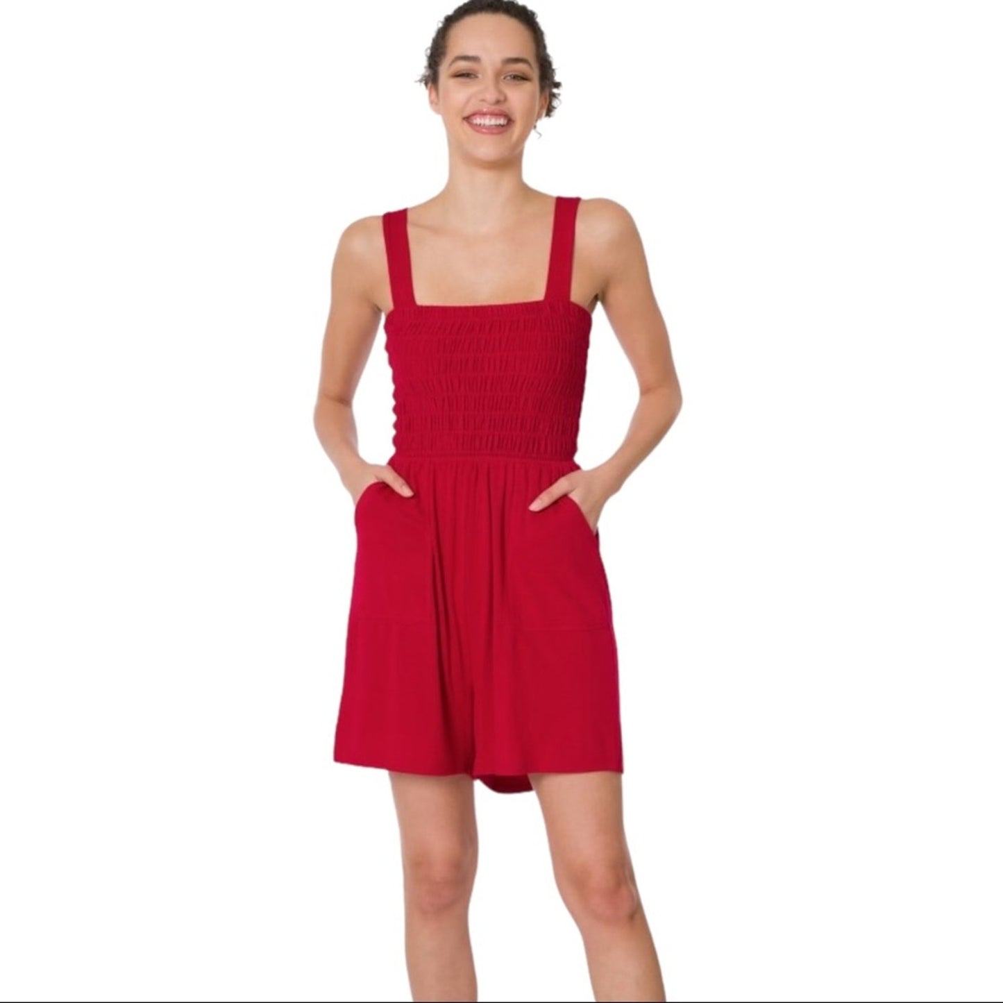 Woman wearing a red romper on a white background