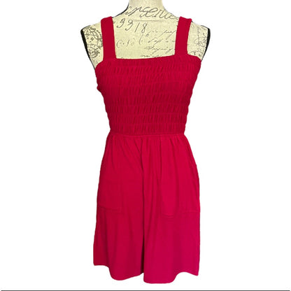 Front of red romper on a mannequin with lace details against a white background