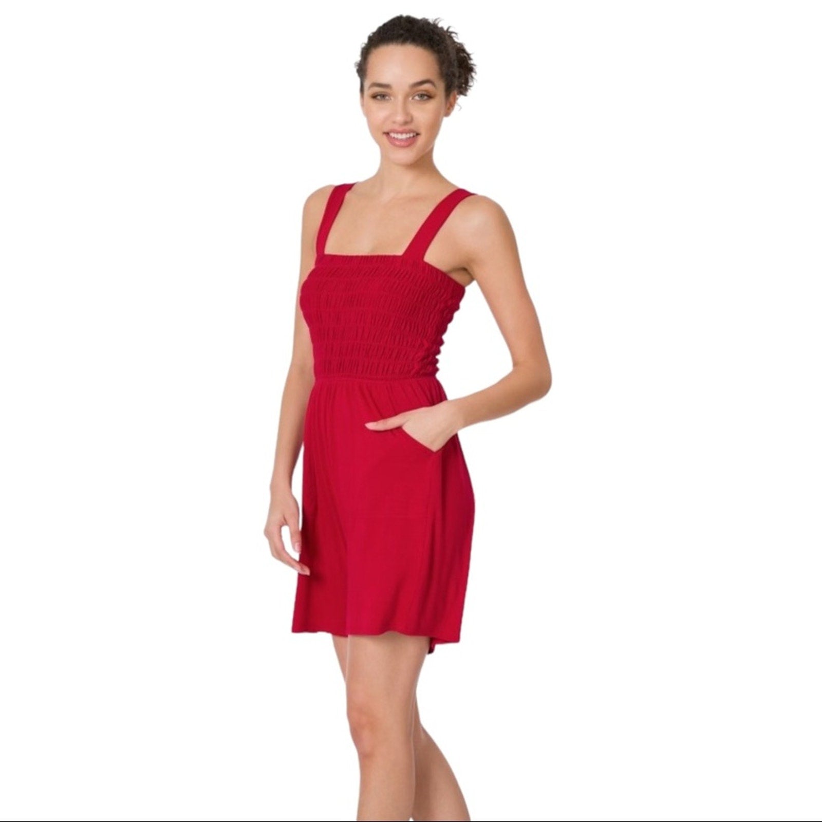 Woman wearing a red romper on a white background