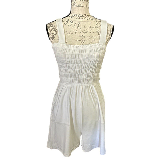 Front of off white romper on a mannequin with lace details against a white background