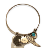 Silver bracelet with 4 charms laying flat