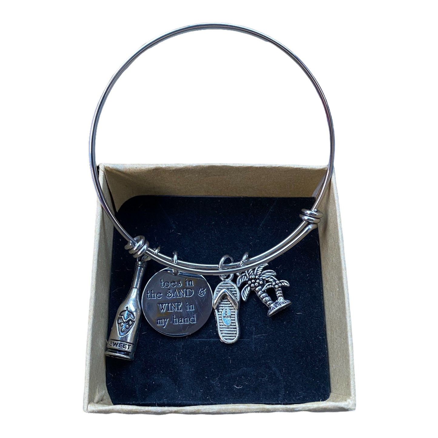 Silver bracelet with 4 charms in a box